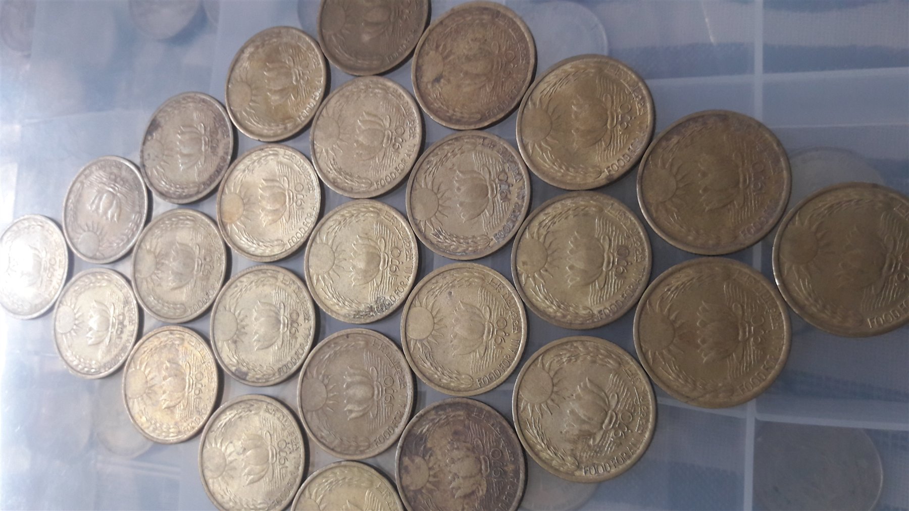 Indian Food for All commemorative coins with lotus and rising-sun motifs arranged as a display