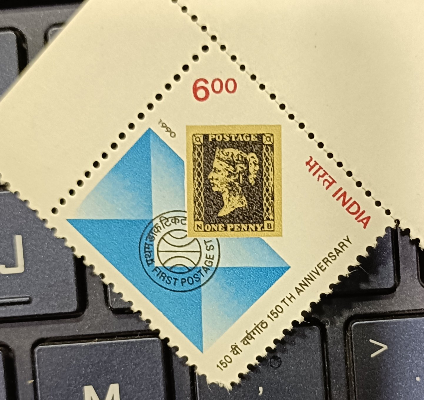 Indian triangular stamp marking the 150th anniversary of the first postage stamp