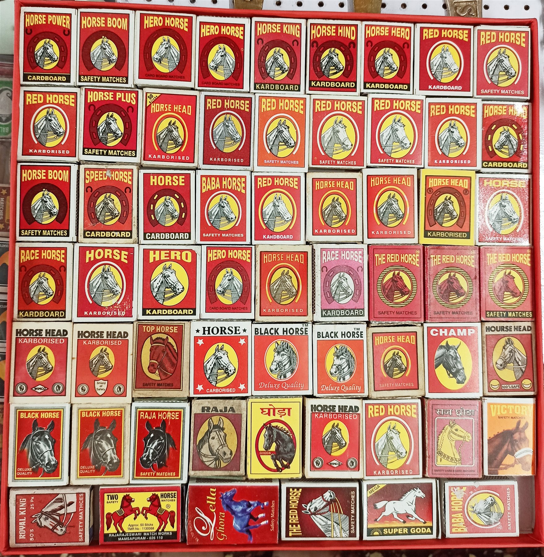 Large display of Indian horse-themed matchboxes and labels